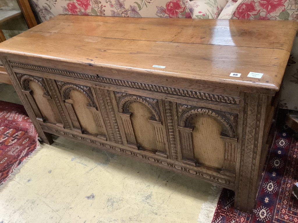 An 18th century and later oak coffer with arch panelled front, width 142cm depth 52cm height 68cm